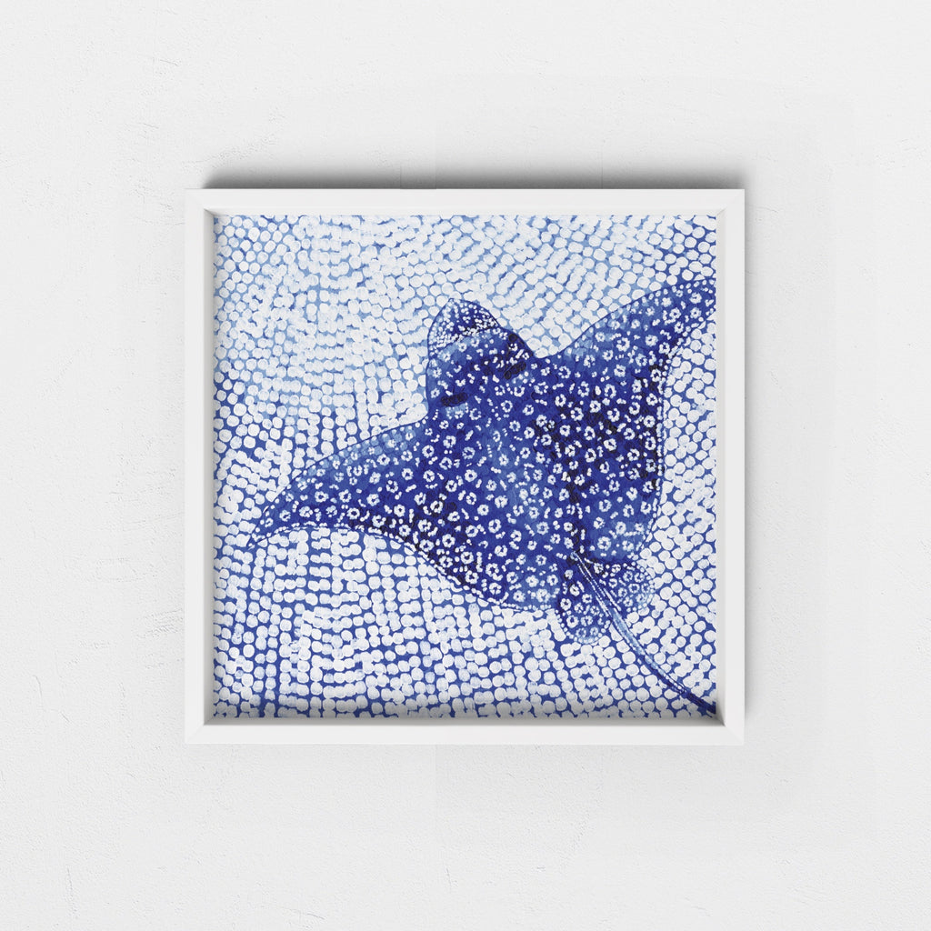 Framed artwork of a blue abstract white spotted eagle ray in a white frame