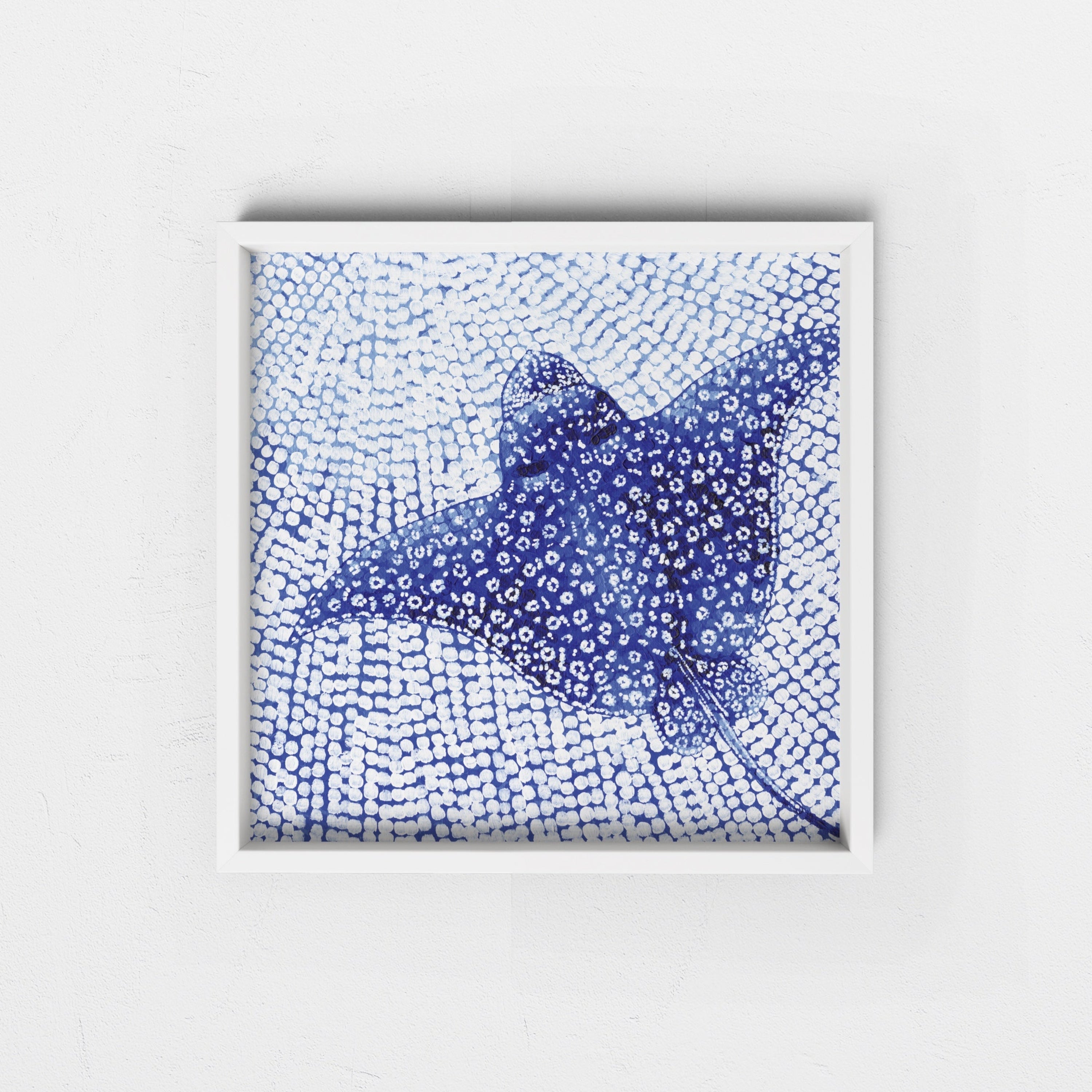 Framed artwork of a blue abstract white spotted eagle ray in a white frame